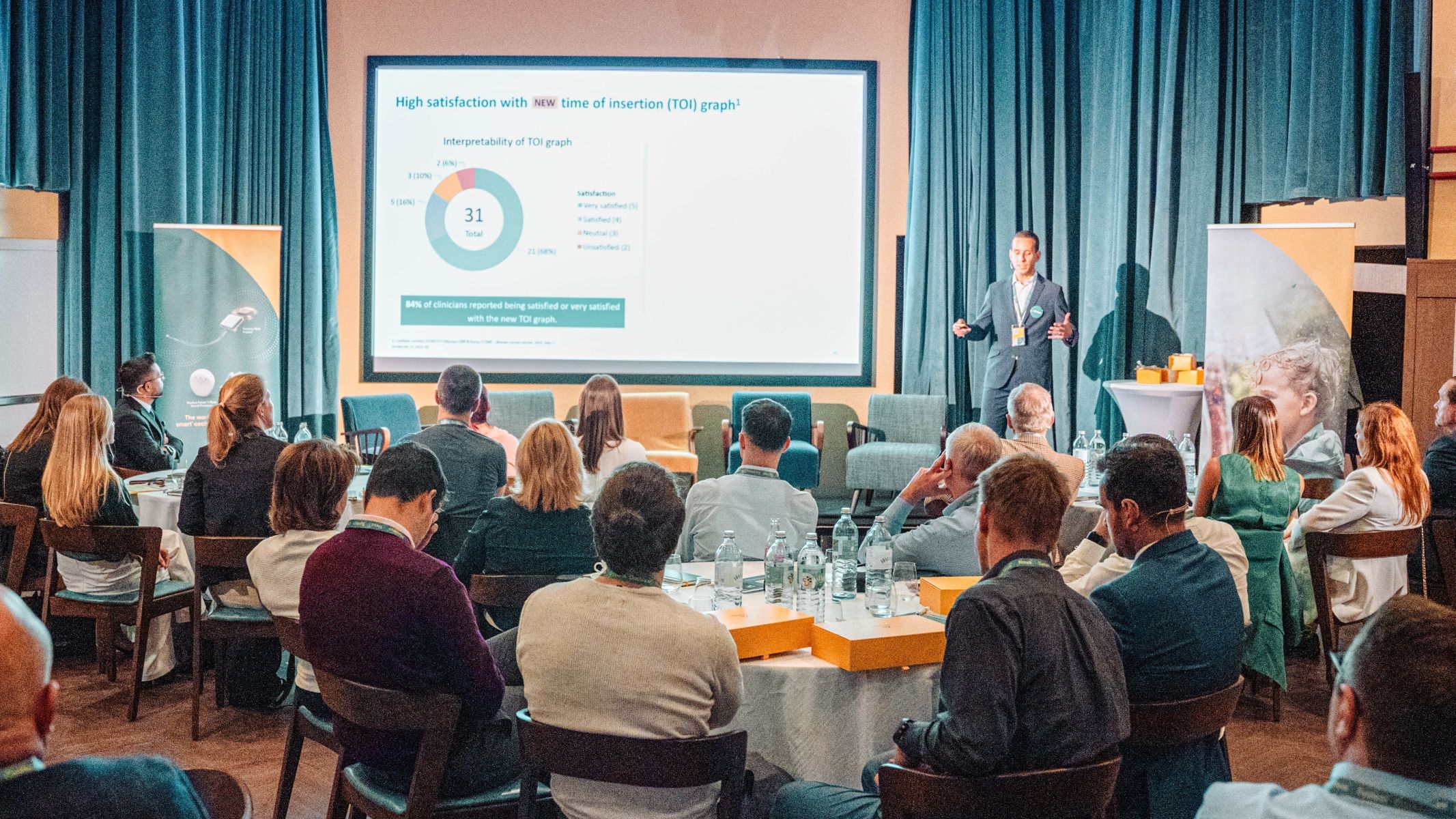 Tiago R. Felix on stage, giving a presentation to an audience.